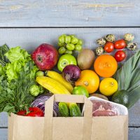 Healthy food background. Paper bag with healthy food